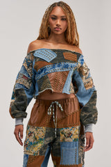 CALL ME CRAZY PATCHWORK OFF THE SHOULDER SWEATSHIRT IN BROWN MULTI